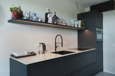 a kitchen with a sink and a counter top at BB aan de Zuyderzee in Bunschoten
