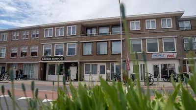 a building on a street with bikes parked outside at Shoreline Apartment Katwijk in Katwijk aan Zee