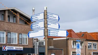 a street sign with many signs on a pole at Shoreline Apartment Katwijk in Katwijk aan Zee