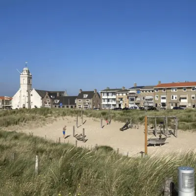 a beach with a group of people playing in the sand at Shoreline Apartment Katwijk in Katwijk aan Zee