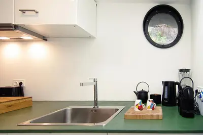 a kitchen with a sink and a counter top at Magnificent houseboat with a stunning view! in Amsterdam