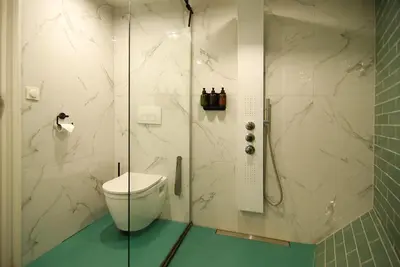 a bathroom with a toilet and a glass shower at Magnificent houseboat with a stunning view! in Amsterdam