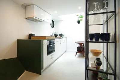a kitchen with white cabinets and a stove top oven at Magnificent houseboat with a stunning view! in Amsterdam
