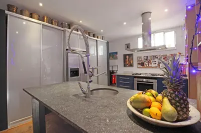 a kitchen with a bowl of fruit on a counter at Elegant penthouse LOFT of 250 m2 in city centre with huge roofgarden 80 m2 in Amsterdam
