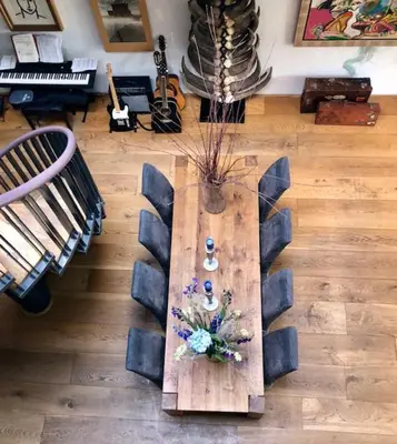 a living room with a table with flowers on it at Elegant penthouse LOFT of 250 m2 in city centre with huge roofgarden 80 m2 in Amsterdam