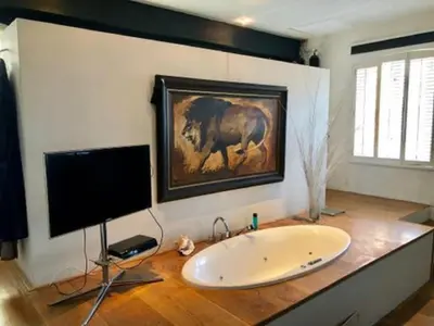 a bathroom with a sink and a painting of a horse at Elegant penthouse LOFT of 250 m2 in city centre with huge roofgarden 80 m2 in Amsterdam