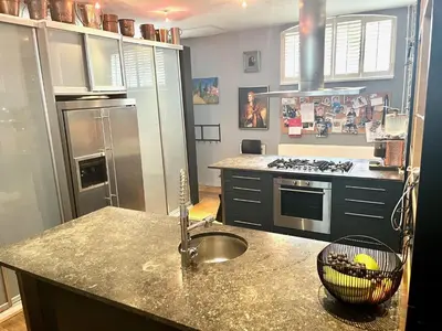 a kitchen with a sink and a counter top at Elegant penthouse LOFT of 250 m2 in city centre with huge roofgarden 80 m2 in Amsterdam