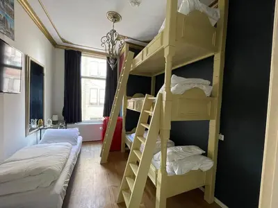 a bunk bed room with two beds and two bunk beds at Amsterdam Rembrandt Square city center Hotel in Amsterdam