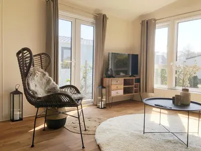 a living room with two chairs and a table at Chalet 578 op Recreatiepark De Wielen in Sint Maarten