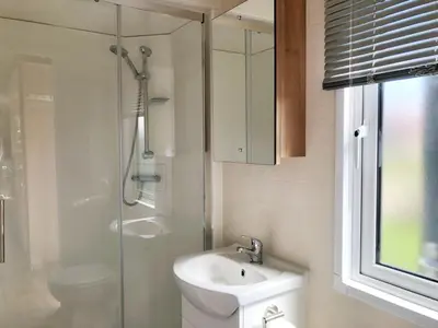 a bathroom with a toilet and a sink and a shower at Chalet 578 op Recreatiepark De Wielen in Sint Maarten