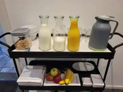 a shelf with three bottles of milk and fruit at B&B Adrina in Zeewolde