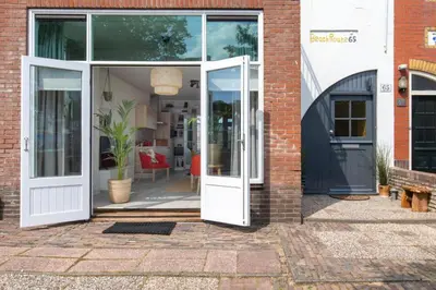 an open door of a brick building at Nina's Beach House 2 