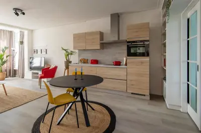 a kitchen with a table and chairs in a room at Nina's Beach House 2 