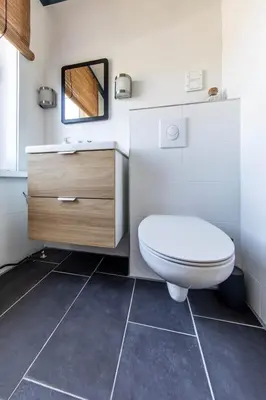 a bathroom with a toilet and a sink at Nina's Beach House 1 