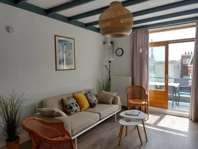 a living room with a couch and a table at Nina's Beach House 1 
