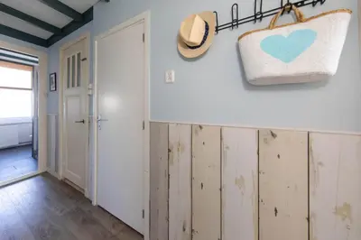 a room with wooden cabinets and a purse on the wall at Nina's Beach House 1 