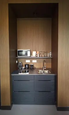 a kitchen with a sink and a stove and a microwave at V Lofts in Amsterdam