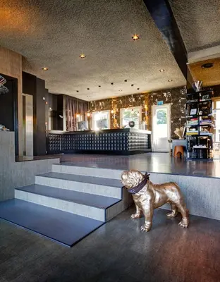 a statue of a dog standing next to some stairs at V Lofts in Amsterdam