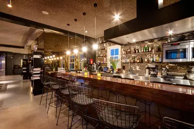 a bar with a row of chairs in a restaurant at V Lofts in Amsterdam