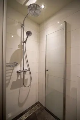a shower with a glass door in a bathroom at Unique Courtyard House with Sauna in Alkmaar city center in Alkmaar