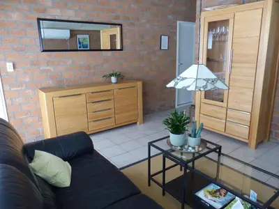 a living room with a couch and a table at Ferienhaus-Naumann-Kreetz in Burgerbrug