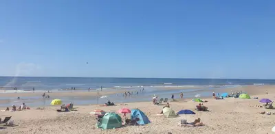 a group of people on a beach with umbrellas at Ferienhaus-Naumann-Kreetz in Burgerbrug