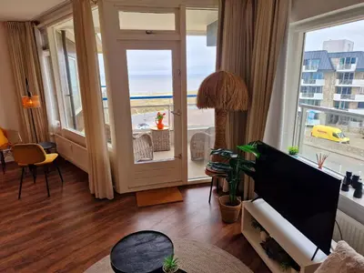 a living room with a view of the ocean at Studio Noordzee in Egmond aan Zee