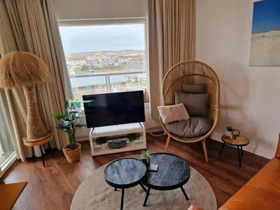 a living room with a television and a couch at Studio Noordzee in Egmond aan Zee