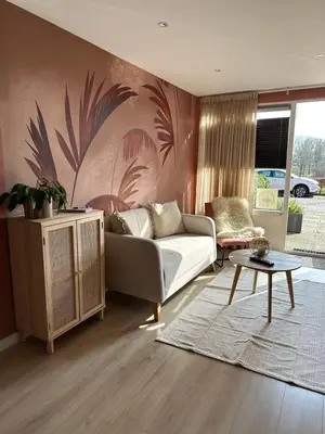 a living room with a couch and a table at Overnachten bij de Haven in Lelystad