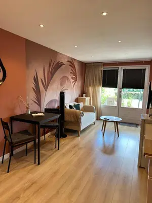 a living room with a couch and a table at Overnachten bij de Haven in Lelystad