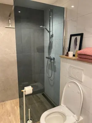 a bathroom with a shower and a toilet at Overnachten bij de Haven in Lelystad