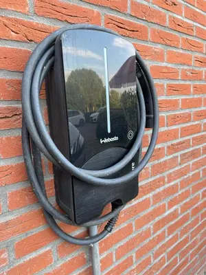 a television is attached to a brick wall at Overnachten bij de Haven in Lelystad