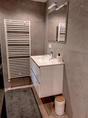 a bathroom with a white sink and a mirror at Overnachten bij de Haven in Lelystad
