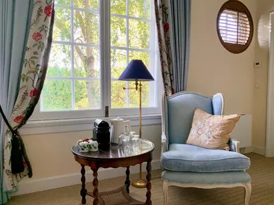 a room with a chair and a table and a window at Fortuna Spinoza in Monnickendam