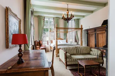 a living room with a bed and a couch and a table at Fortuna Spinoza in Monnickendam