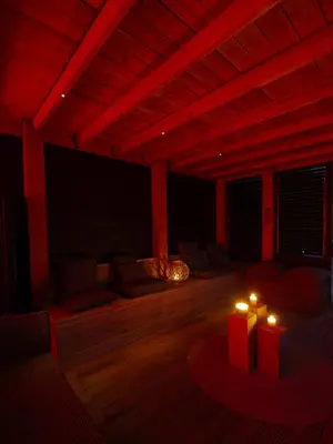 a living room with red lighting and two candles at Luxurious Family Villa with sauna big garden and jacuzzi in Zeewolde