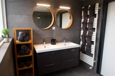 a bathroom with a sink and two mirrors at Luxurious Family Villa with sauna big garden and jacuzzi in Zeewolde