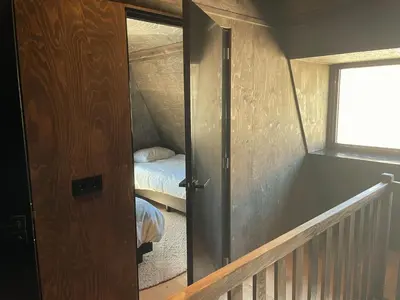 an open door to a bedroom with a bed at Park Heerehof in Schoorl