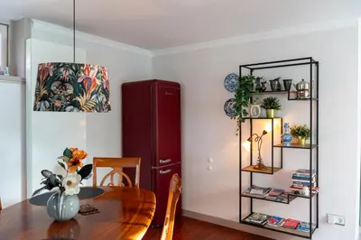a dining room with a table and a red cabinet at Munnik's Hof in Amsterdam