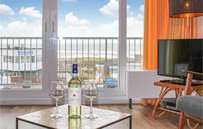 a bottle of wine sitting on a table with two wine glasses at De Tuimelaar in Bergen aan Zee