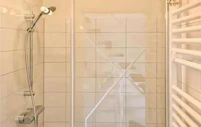 a shower with a glass door in a bathroom at De Tuimelaar in Bergen aan Zee