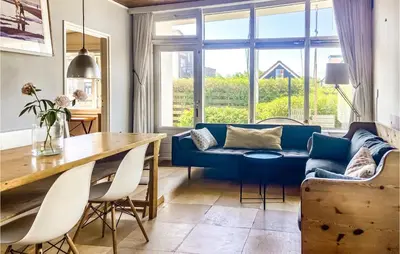 a living room with a blue couch and a table at 'T Zilt in Bergen aan Zee