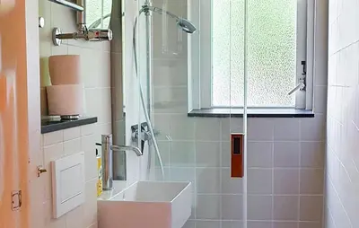 a bathroom with a shower with a sink and a sink at 'T Zilt in Bergen aan Zee