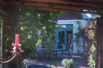 a patio of a house with a table and chairs at Vakantiewoning De Lotus in Hoevelaken