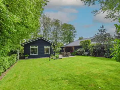 a home with a yard with a house at De IJsvogel in Heiloo