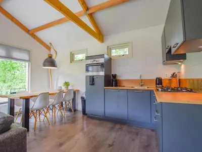 a kitchen with a blue refrigerator and a table at De IJsvogel in Heiloo