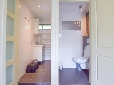 a bathroom with a toilet and a sink at De IJsvogel in Heiloo