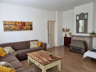 a living room with a couch and a coffee table at Het Voorhuis boerderij Hoeve Vrede Best in Weesp