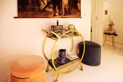 a room with a hanger and a table with a hat at Najade Eco Houseboat in Amsterdam