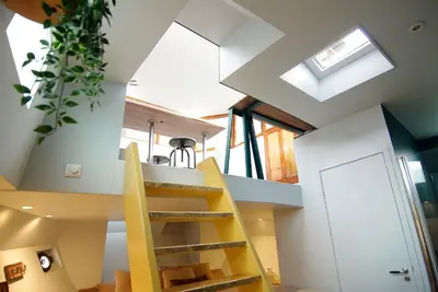 a spiral staircase in a house with a skylight at Najade Eco Houseboat in Amsterdam